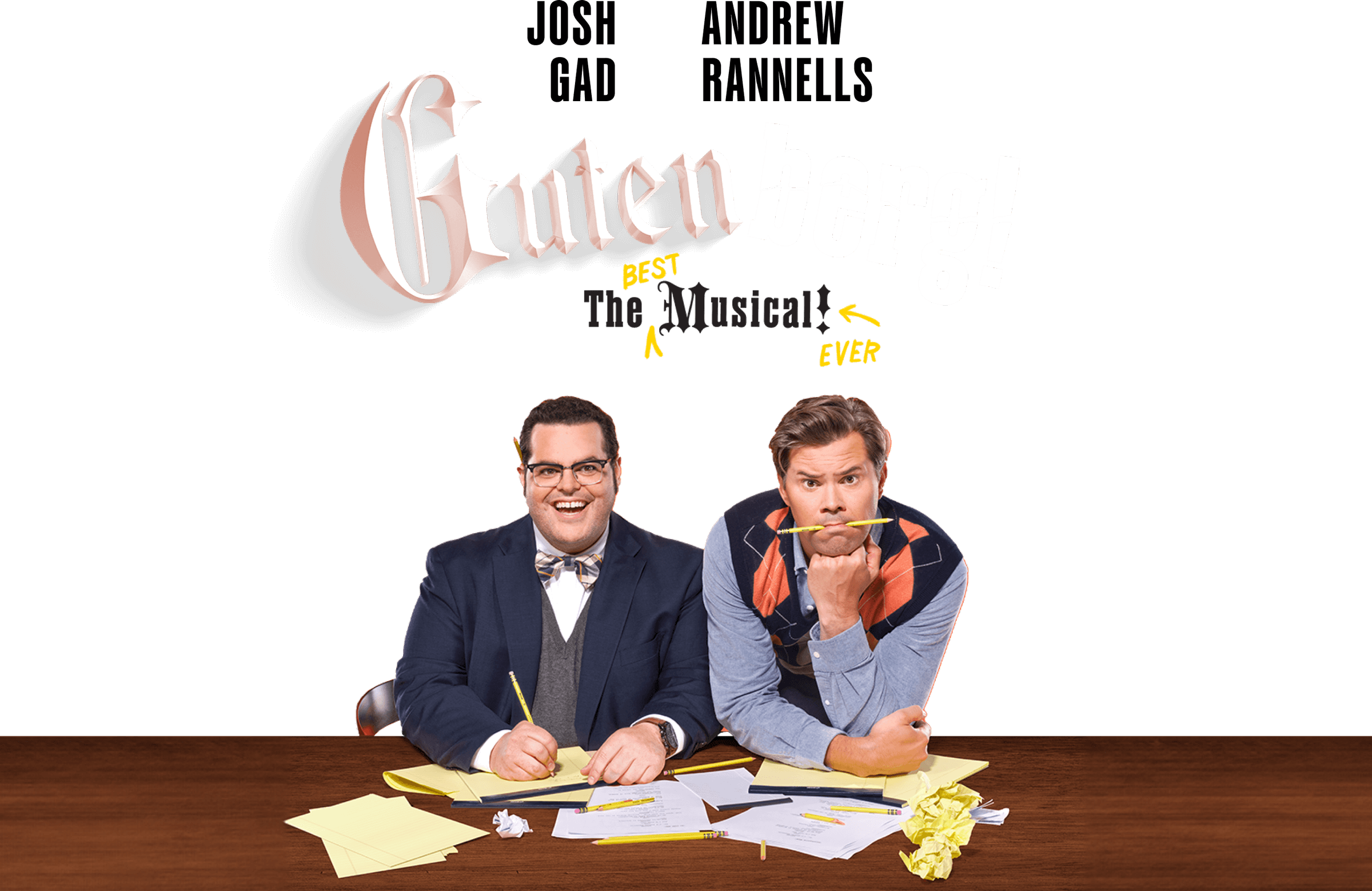 Show Art: Josh Gad, Andrew Rannells in Gutenberg! The best Musical ever Photo of Josh Gad (Bud Davenport) and Andrew Rannells (Doug Simon) at a table writing with Rannells holding a pencil in his mouth.